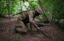A Ukrainian special operations unit soldier lays a Germany-donated DM22 directional anti-tank mine on the Russian troops' potential path in the Donetsk region, June 14, 2022.