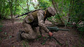 A Ukrainian special operations unit soldier lays a Germany-donated DM22 directional anti-tank mine on the Russian troops' potential path in the Donetsk region, June 14, 2022.