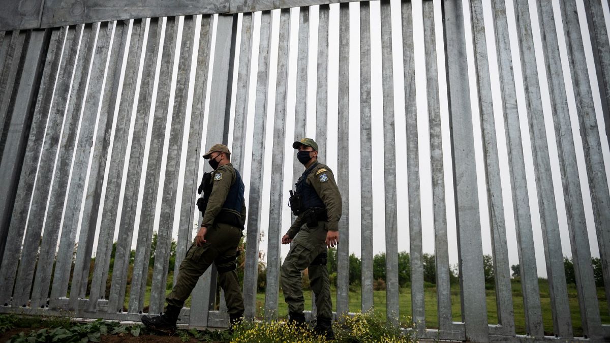 Police officers patrol alongside a steel wall at Evros river, near the village of Poros, at the Greek-Turkish border, Greece, May 21, 2021.