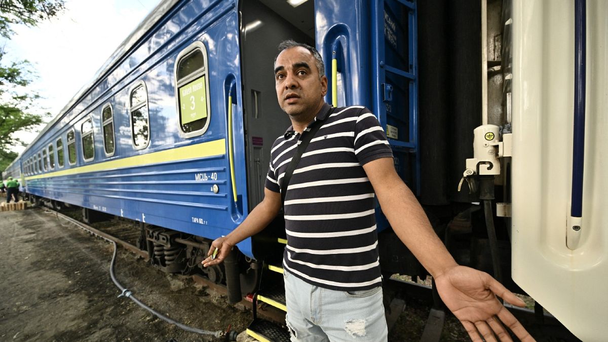 Denys, 39, reacts in front of a rail car made available by Ukrainian Railways in Irpin on June 15, 2022.