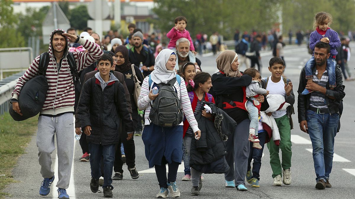Migrants walk on a motorway towards Vienna after crossing the Hungarian border.