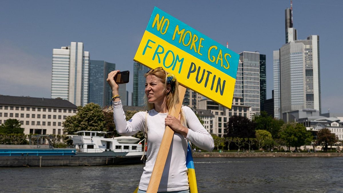 A protester holds a placard reading "No more gas from Putin" during a pro-Ukrainian protest. 