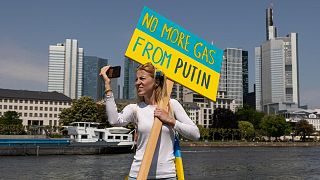 A protester holds a placard reading "No more gas from Putin" during a pro-Ukrainian protest.