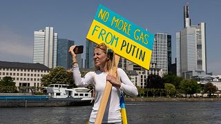 A protester holds a placard reading "No more gas from Putin" during a pro-Ukrainian protest. 