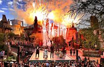 Fireworks blast during the dedication ceremony with invited guests at the entrance of the Star Wars: Galaxy's Edge attraction at Disney's Hollywood Studios, August, 2019.