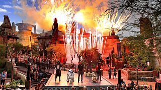 Fireworks blast during the dedication ceremony with invited guests at the entrance of the Star Wars: Galaxy's Edge attraction at Disney's Hollywood Studios, August, 2019. 