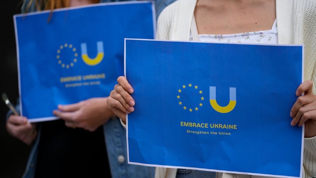 Members of the Ukrainian community in Portugal demonstrate outside the Netherlands embassy in Lisbon in support of Ukraine joining the European Union, Wednesday, June 15, 2022