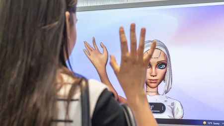 A visitor to VivaTech tries out some of the tech being showcased at the L'Oreal pavilion.
