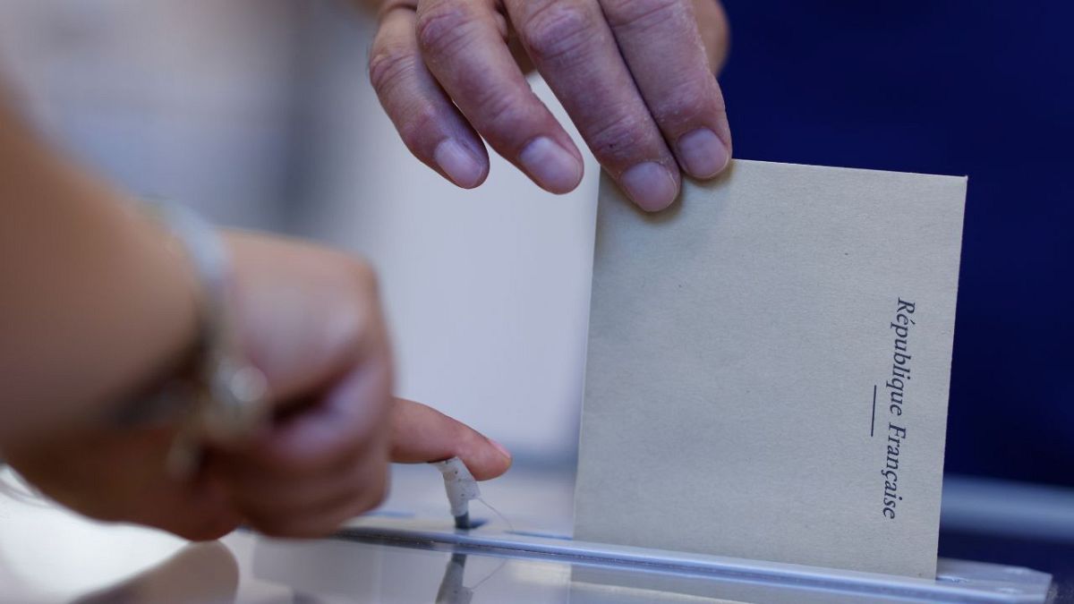 A man casts his ballot at a voting station in Strasbourg, eastern France, Sunday June 12, 2022.