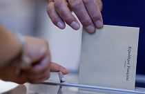 A man casts his ballot at a voting station in Strasbourg, eastern France, Sunday June 12, 2022.