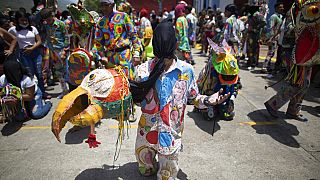 Members of the Dancing Devils take part in the Catholic celebration of Corpus Christi.