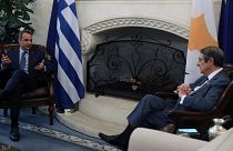 Cypriot President Nicos Anastasiades, right, and Greek Prime Minister Kyriakos Mitsotakis talk during their meeting at the Presidential Palace in Nicosia, Cyprus, Friday, June