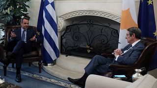 Cypriot President Nicos Anastasiades, right, and Greek Prime Minister Kyriakos Mitsotakis talk during their meeting at the Presidential Palace in Nicosia, Cyprus, Friday, June