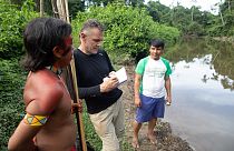 November 16, 2019 Veteran foreign correspondent Dom Phillips (C) talks to two indigenous men in Aldeia Maloca Papiú, Roraima State, Brazil.