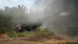 Ukrainian soldiers fire at Russian positions from a US-supplied M777 howitzer in Donetsk, 18 June 2022