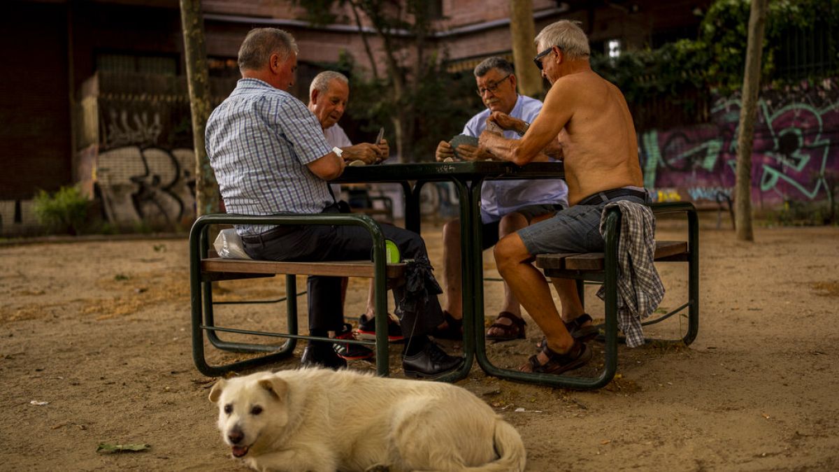 Men play cards during a hot day in Madrid, Spain, June 17, 2022. 