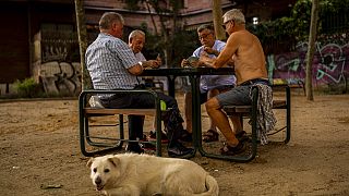 Men play cards during a hot day in Madrid, Spain, June 17, 2022.