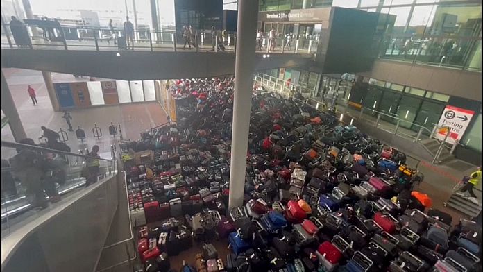 Piles of luggage carpet area of Heathrow Airport