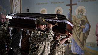 Soldiers carry the coffin of activist and soldier Roman Ratushnyi for his memorial service in Kyiv, 18 June 2022