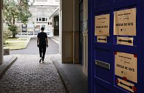 A voter arrives at a voting station in Paris on 19 June 2022.