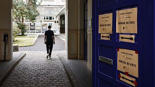 A voter arrives at a voting station in Paris on 19 June 2022.