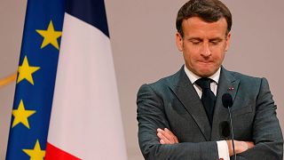 French President Emmanuel Macron looks down during the traditional Lily of the valley ceremony at the Elysee Palace in Paris Saturday May 1, 2021.