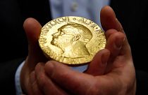 FILE — Bidder Ole Bjorn Fausa, of Norway, holds the 1936 Nobel Peace Prize medal in Baltimore, March 27, 2014, the second Nobel Peace Prize ever to come to auction.