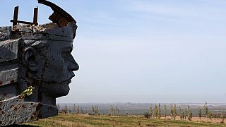A picture shows a damaged statue at the World War II Savur Mohyla memorial in Snizhne, some 80km east of Donetsk, on October 15, 2014.
