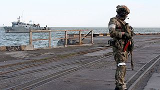 A Russian serviceman stands guarding an area of the Mariupol Sea Port in Mariupol, eastern Ukraine, Friday, May 27, 2022