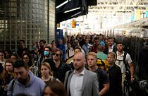 Passengers disembark from one of the few trains to arrive this morning at Waterloo railway station in London