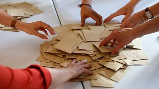 Volunteers count ballots in a polling station Sunday, June 19, 2022 in Bischeim, outside Strasbourg, eastern France.