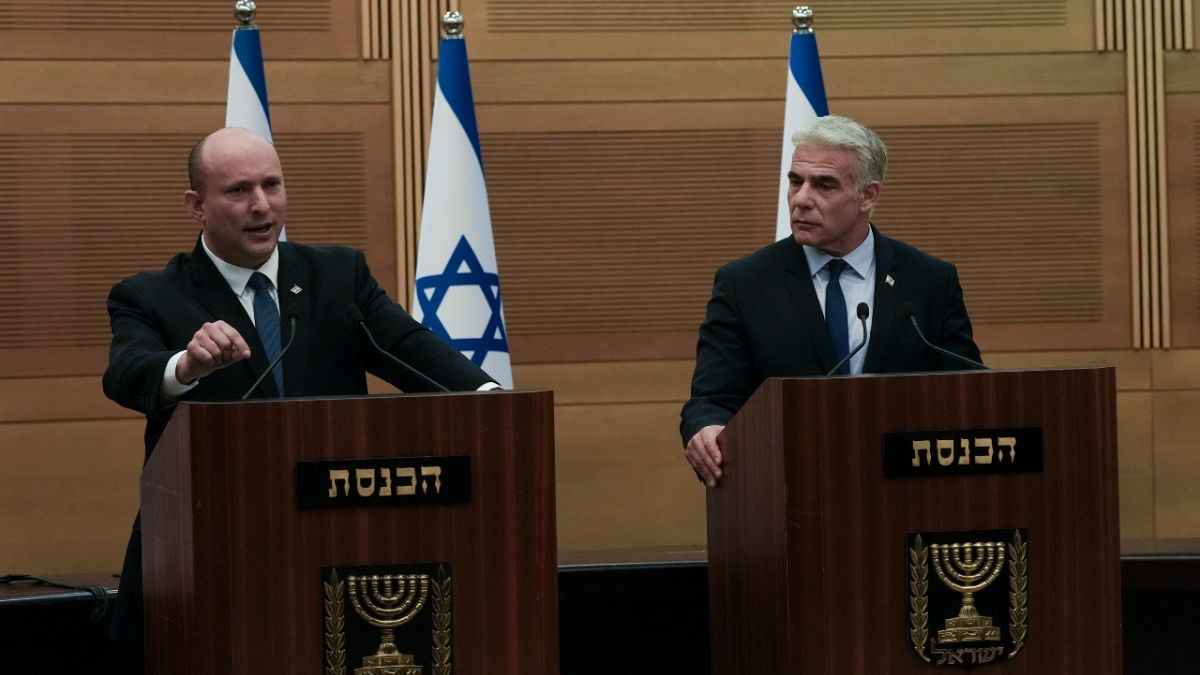 Israeli Prime Minister Naftali Bennett (L), speaks during a joint statement with Foreign Minister Yair Lapid, at the Knesset, Israel's parliament, in Jerusalem, June 20, 2022.