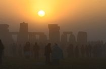 Revellers gather to celebrate the Summer Solstice at sunrise at Stonehenge stone circle near Amesbury