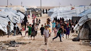 FILE - Children gather outside their tents, at al-Hol camp, which houses families of members of the Islamic State group, in Hasakeh province, Syria, May 1, 2021.