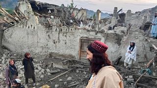 Afghans look at destruction caused by an earthquake in the province of Paktika, eastern Afghanistan, Wednesday, June 22, 2022