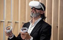 An attendee tries out a Meta virtual reality headset during the Vivatech technology startups and innovation fair in Paris on May 15, 2022.