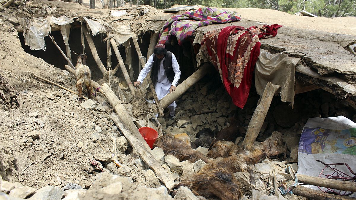 یک مرد افغان در میان آوارهای سکونت‌گاه خود؛ ۲۲ ژوئن ۲۰۲۲