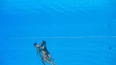 المدربة أندريا فوينتيس تمسك تحت الماء بالسباحة الأمريكية أنيتا ألفاريز.