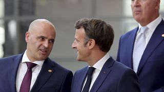 North Macedonia's Prime Minister Dimitar Kovacevski, left, speaks with French President Emmanuel Macron 