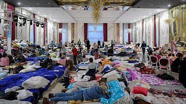 Refugees who fled the Russian invasion are pictured inside a makeshift shelter in Suceava, Romania.