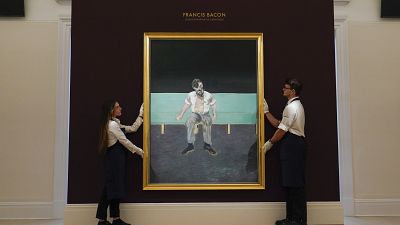 Members of the staff hold 'Study for Portrait of Lucian Freud' by Francis Bacon at Sotheby's, in London