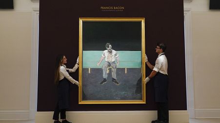 Members of the staff hold 'Study for Portrait of Lucian Freud' by Francis Bacon at Sotheby's, in London