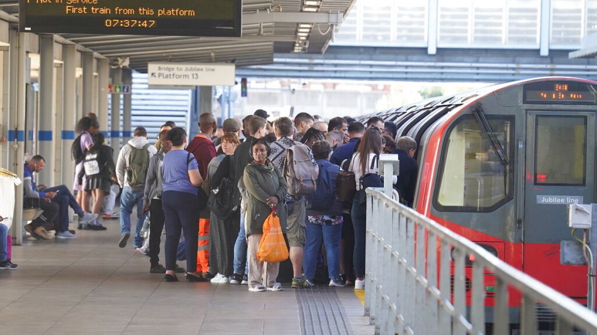 Пассажиры выстроились в очередь на входе в вагон лондонского метро в день всеобщей стачки транспортников в Великобритании. 