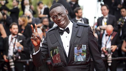 Khaby Lame poses for photographers upon arrival at the premiere of the film 'Top Gun: Maverick' at the 75th international film festival, Cannes, southern France (2022).