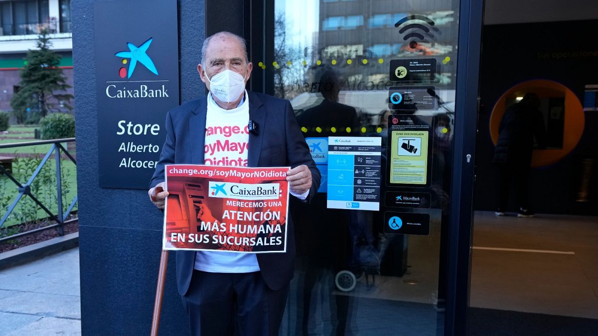 Carlos San Juan, 78, a Spanish retiree poses outside a bank in Madrid, Spain Tuesday Feb. 8, 2022.