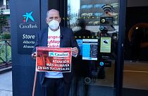 Carlos San Juan, 78, a Spanish retiree poses outside a bank in Madrid, Spain Tuesday Feb. 8, 2022.