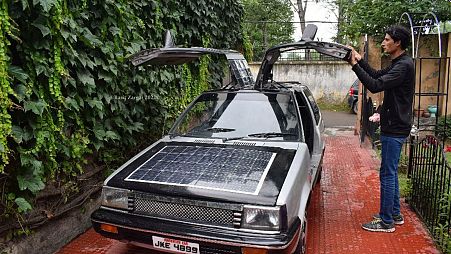 Bilal Ahmed, a maths teacher from Srinagar, with the solar car he developed.