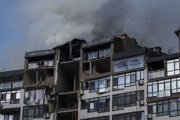Smoke billows the air from a residential buildings following explosions, in Kyiv, 26 June 2022