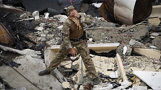 Ein ukrainischer Soldat betrachtet den zerstörten Sportkomplex der Nationalen Technischen Universität in Charkiw