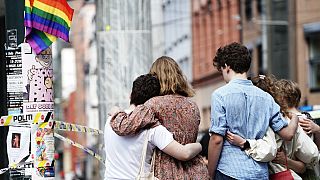 Young people mourn at a crime scene in central Oslo, Norway, on June 25, 2022, in the aftermath of a shooting outside pubs and nightclubs.